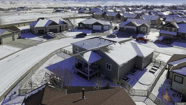 snowy aerial view with a residential view