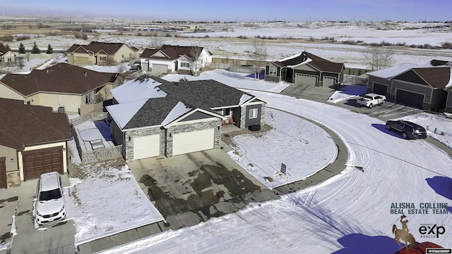 snowy aerial view featuring a residential view