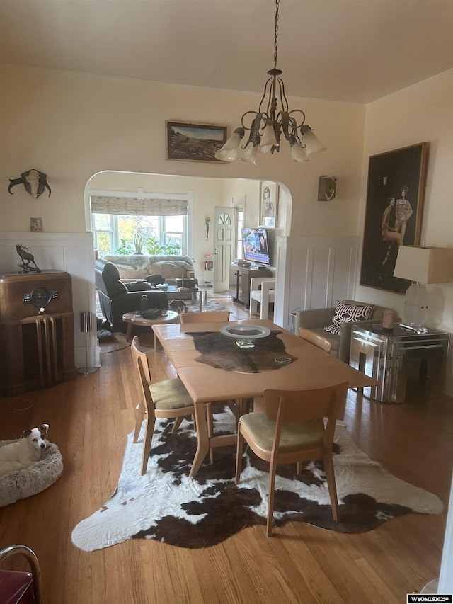 dining space with a chandelier and wood finished floors