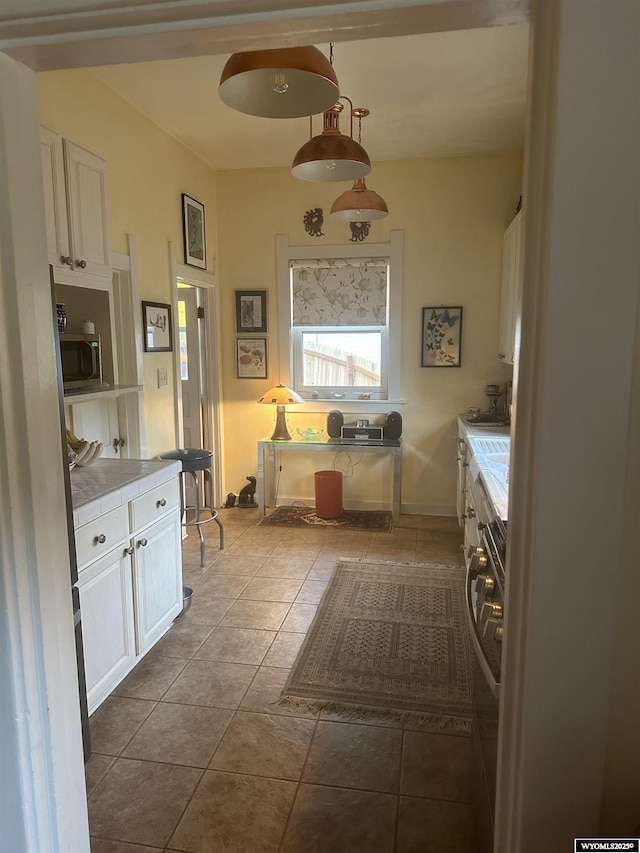 washroom featuring laundry area, tile patterned flooring, and washer / clothes dryer