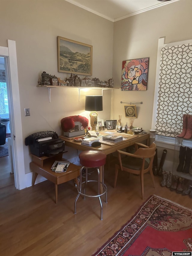 dining room with ornamental molding and wood finished floors