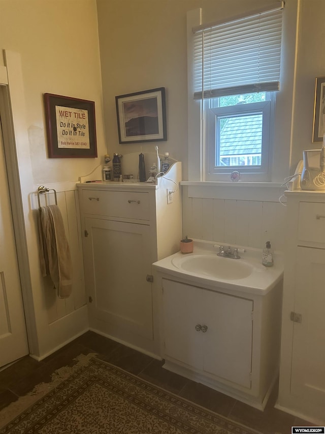 bathroom featuring a wainscoted wall and a sink