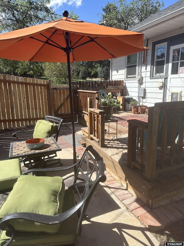 view of patio / terrace featuring a wooden deck and fence