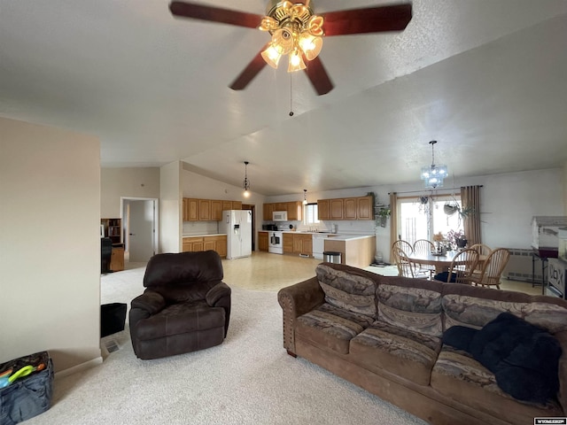 living room featuring vaulted ceiling, ceiling fan with notable chandelier, and light carpet