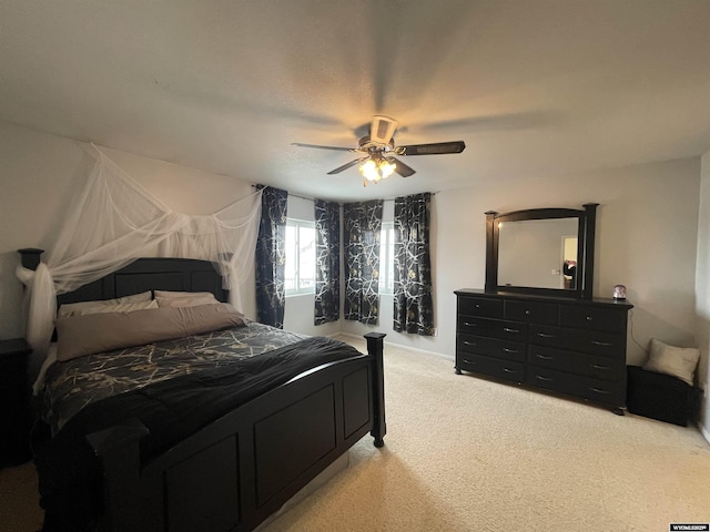 bedroom featuring light carpet and a ceiling fan