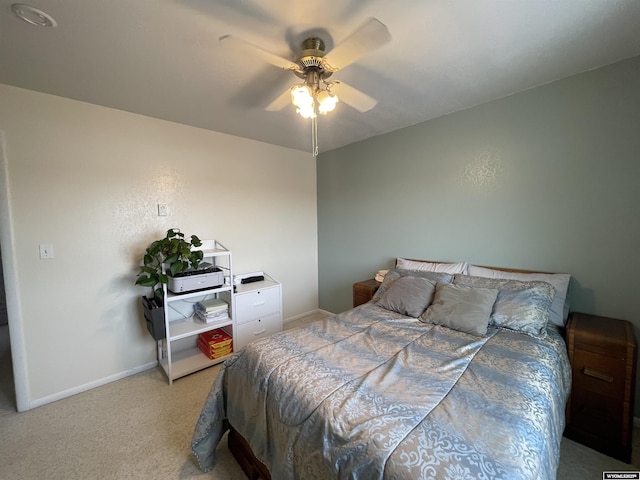 bedroom with light carpet, a ceiling fan, and baseboards