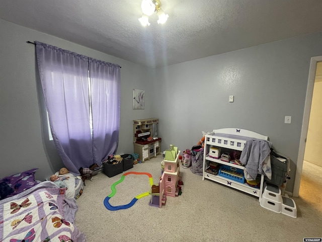 bedroom featuring a textured ceiling and carpet