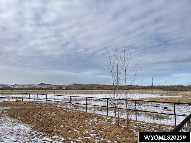 view of yard with a rural view and fence