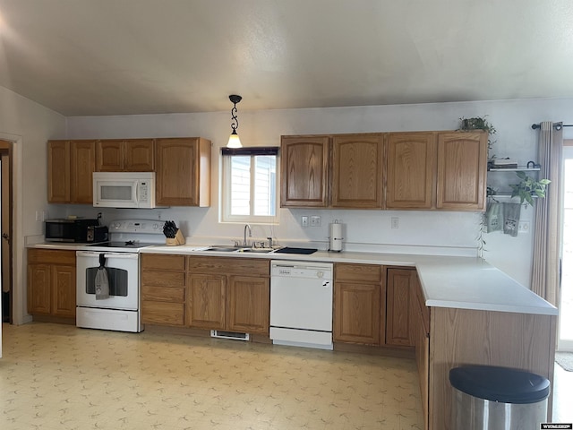 kitchen with white appliances, light countertops, light floors, pendant lighting, and a sink