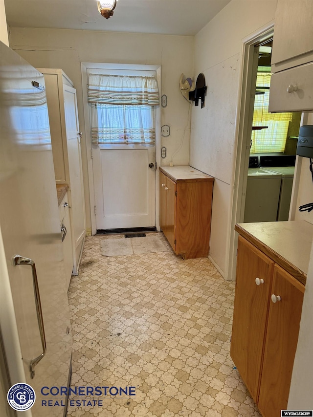 doorway featuring light floors and washer / clothes dryer