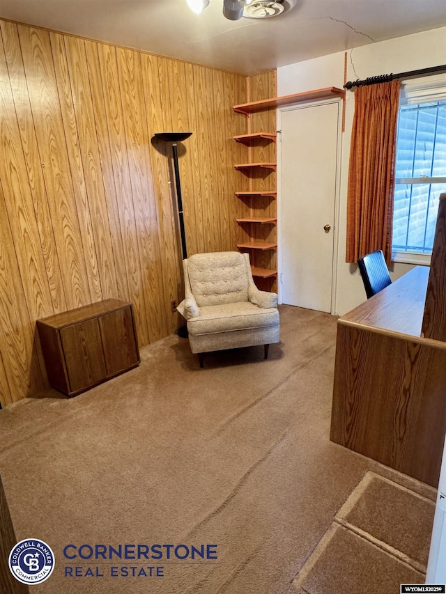 unfurnished office featuring carpet floors and wood walls