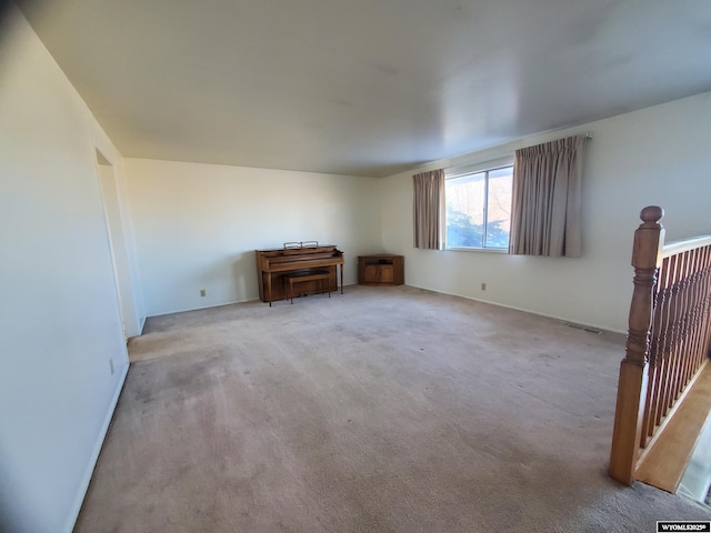 unfurnished living room featuring carpet flooring and visible vents