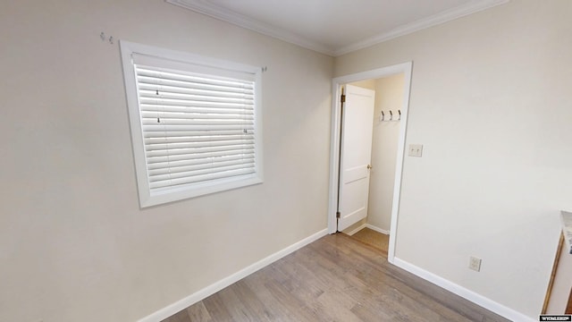 unfurnished bedroom with light wood finished floors, baseboards, and ornamental molding