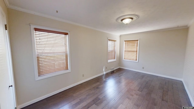 unfurnished room featuring dark wood-style floors, baseboards, and ornamental molding