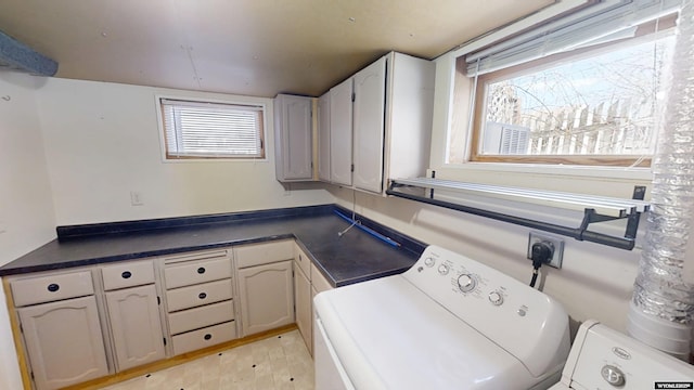 clothes washing area with light wood-type flooring, cabinet space, and separate washer and dryer