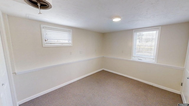 spare room with carpet and baseboards