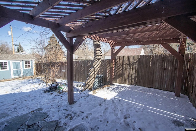 exterior space featuring an outbuilding, a fenced backyard, a storage unit, and a pergola