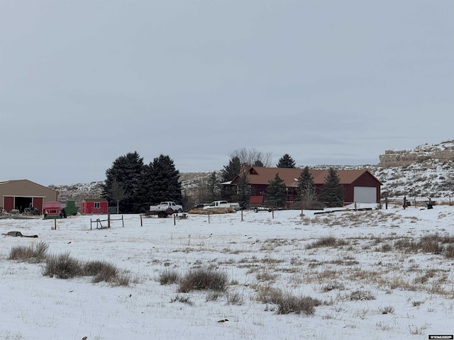 yard covered in snow with a detached garage