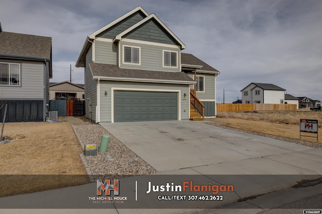 view of front facade featuring a garage, fence, cooling unit, and concrete driveway