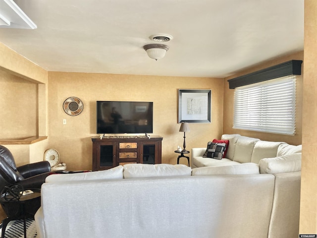 living room featuring visible vents