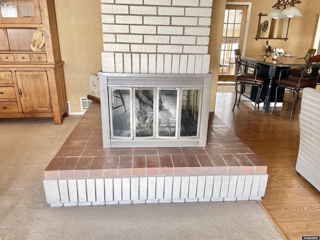 room details with visible vents, baseboards, and wood finished floors