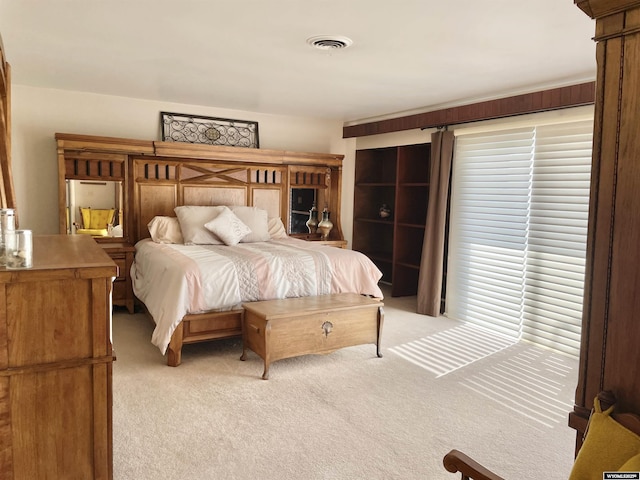 bedroom with light carpet, multiple windows, and visible vents