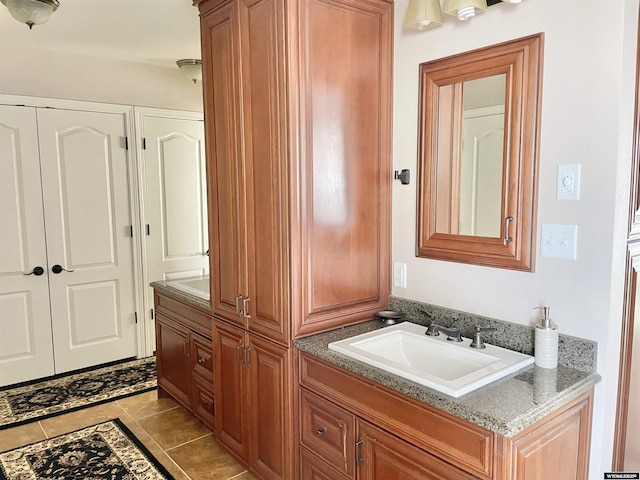 bathroom featuring tile patterned flooring and vanity