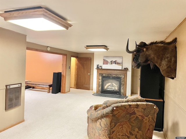 carpeted living room featuring a glass covered fireplace