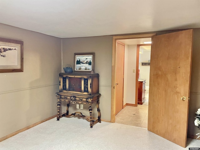 hall with light carpet and baseboards