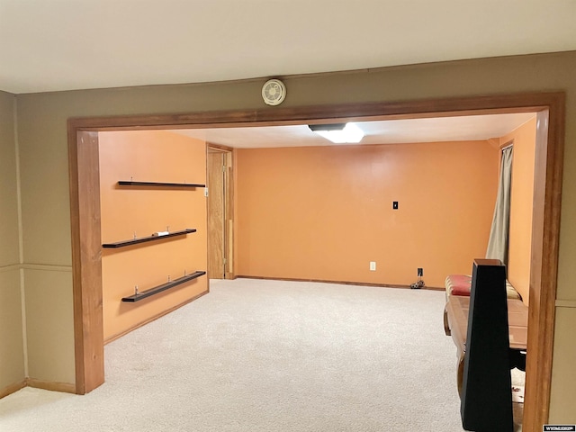 finished basement with light carpet and baseboards