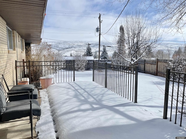 snowy yard with fence