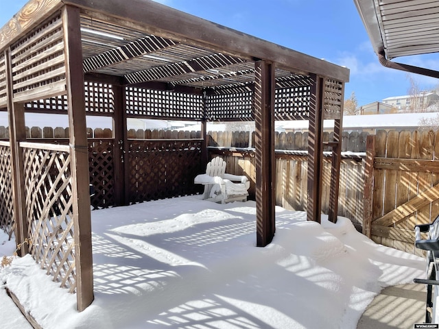 snow covered patio featuring fence