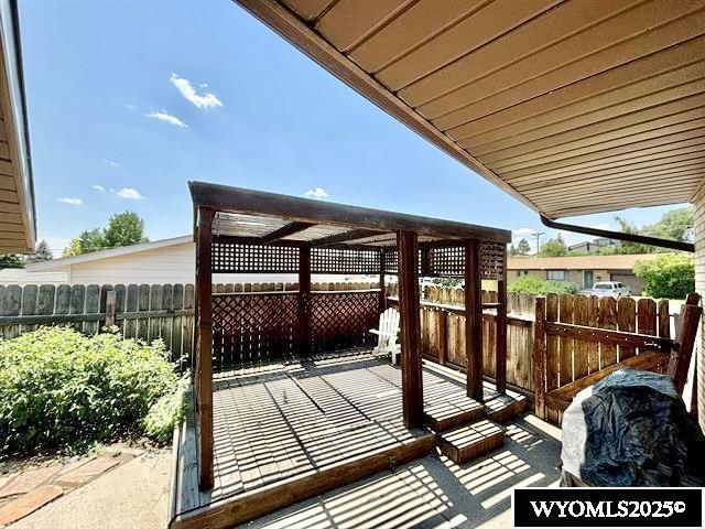 wooden deck with fence and a patio