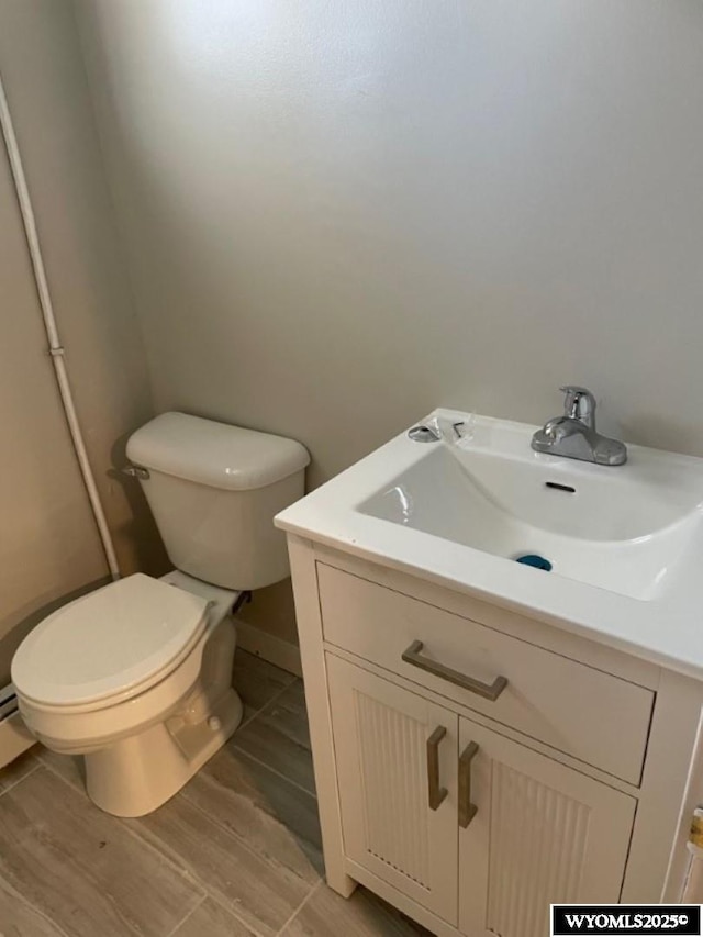 bathroom with toilet and vanity