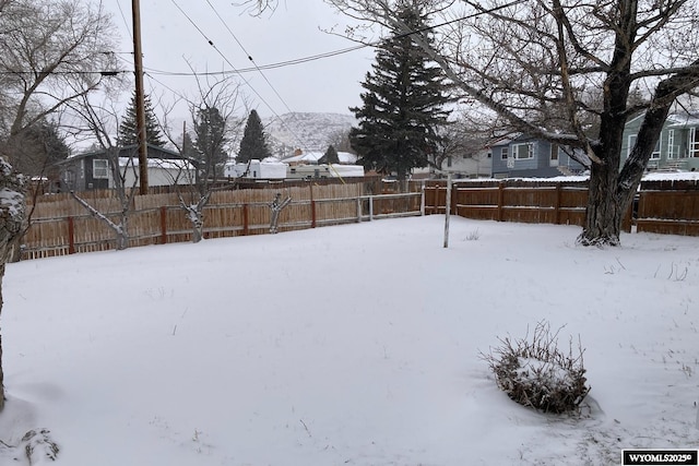 yard covered in snow with fence