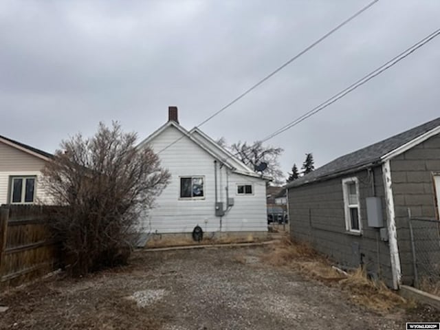 view of side of property featuring fence and driveway