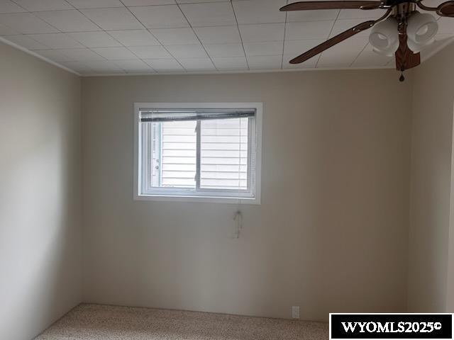 unfurnished room featuring carpet floors and ceiling fan