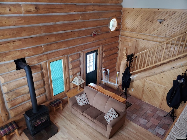 unfurnished living room featuring brick floor and a wood stove