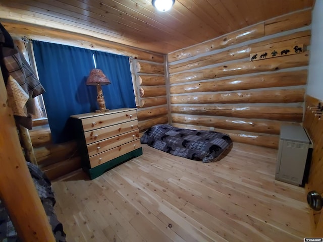 bedroom featuring rustic walls, wood ceiling, and wood finished floors