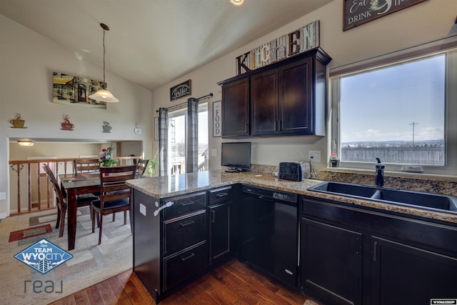 kitchen with decorative light fixtures, dark wood finished floors, vaulted ceiling, a sink, and dishwasher