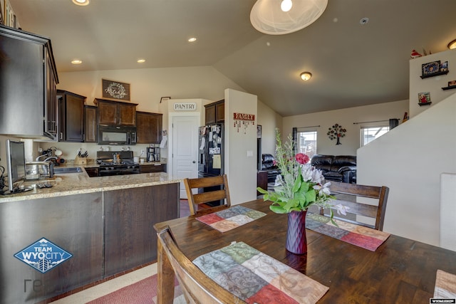 dining area with lofted ceiling and recessed lighting