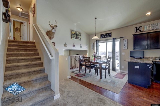 dining room featuring dark wood-style floors, recessed lighting, stairway, vaulted ceiling, and baseboards