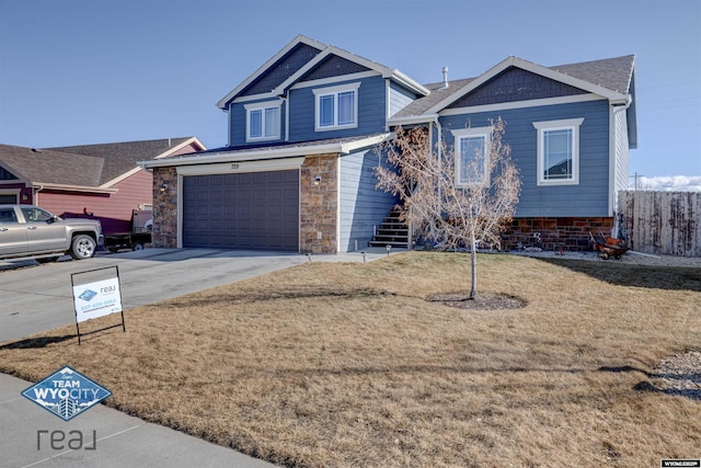 view of front facade featuring concrete driveway, stairway, an attached garage, a front yard, and stone siding