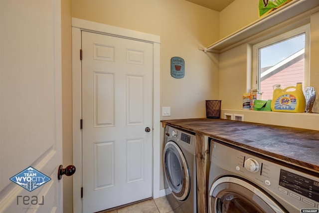 laundry area with light tile patterned floors, laundry area, and washer and clothes dryer