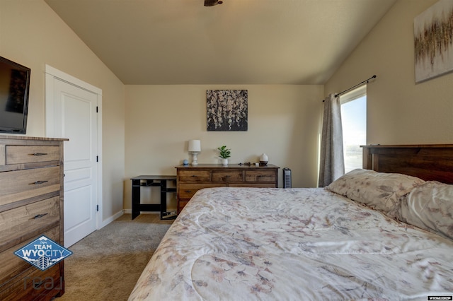 bedroom featuring lofted ceiling, carpet, and baseboards