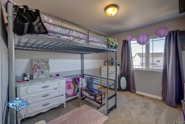 bedroom with light carpet, visible vents, and baseboards