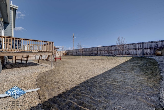 view of yard featuring a fenced backyard and a wooden deck