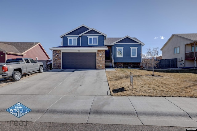 view of front of home featuring a garage, stone siding, a front lawn, and concrete driveway