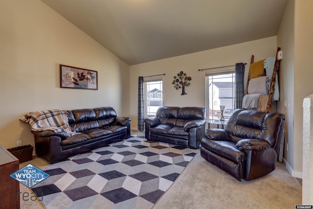 carpeted living area with high vaulted ceiling and baseboards