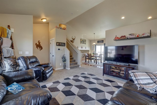 living area featuring baseboards, light colored carpet, stairs, vaulted ceiling, and recessed lighting